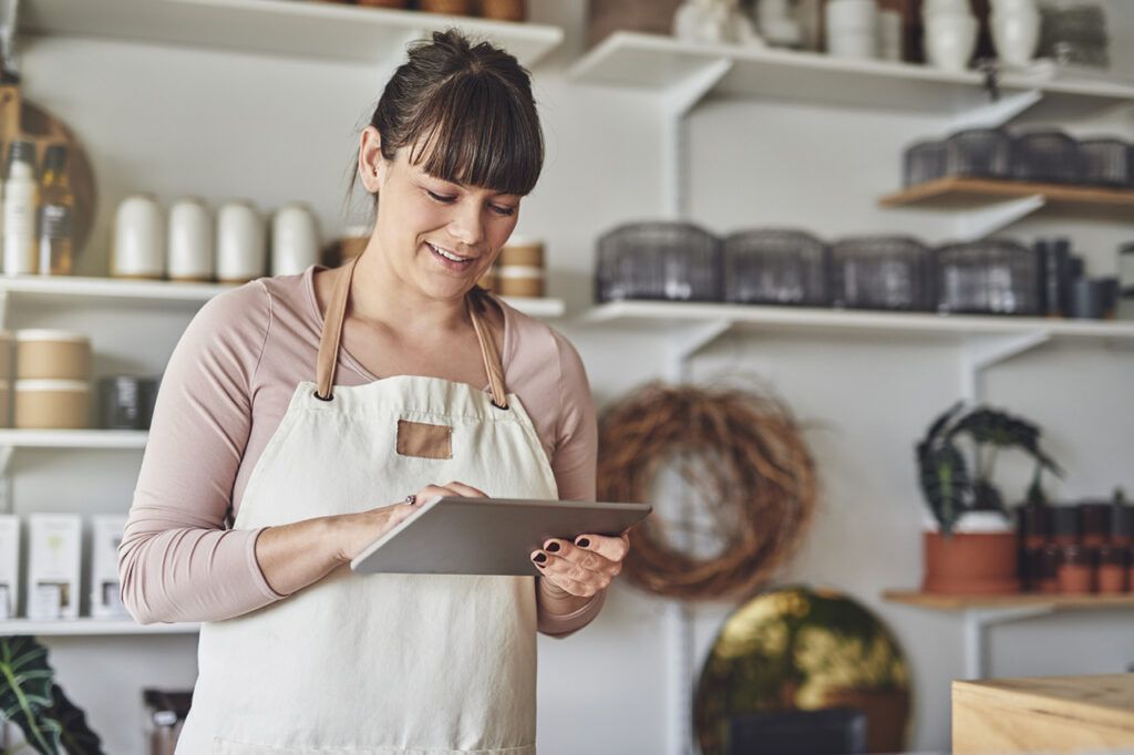 Flower shop owner utilizing florist marketing services