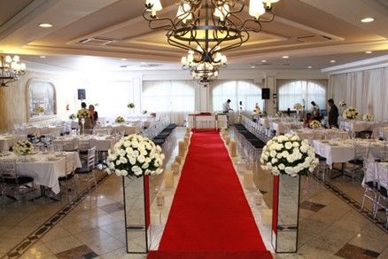 Bountiful white floral arrangements and centerpieces provided for a wedding reception