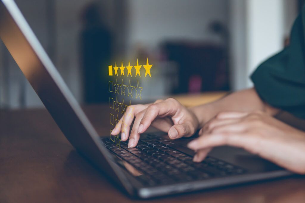 customer leaving Yelp 5-star review for flower shop on laptop